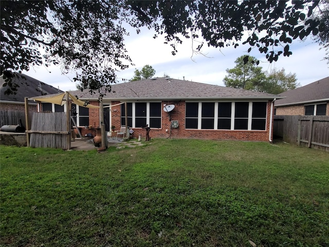 rear view of house featuring a lawn