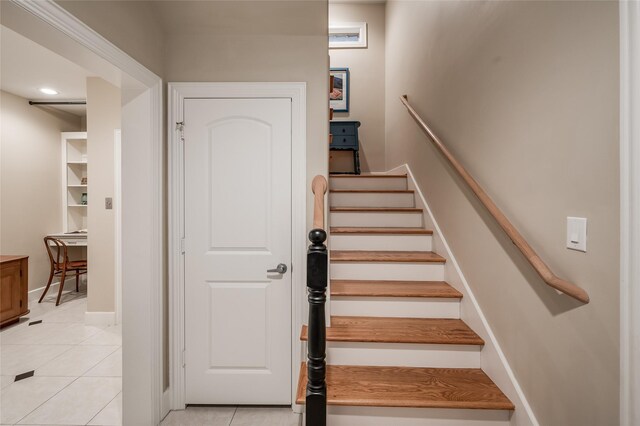 staircase featuring tile patterned flooring