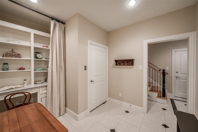 hall with light tile patterned floors