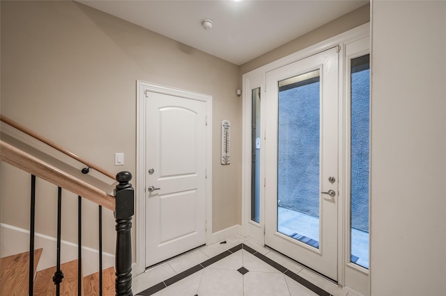 doorway to outside featuring light tile patterned flooring