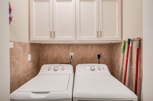 laundry area featuring cabinets and separate washer and dryer