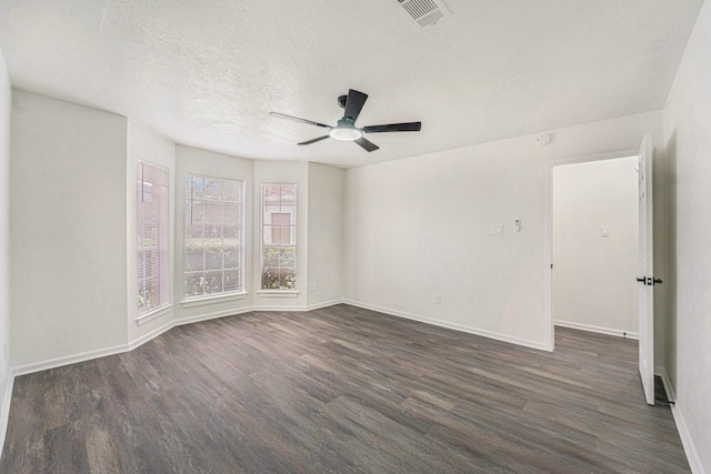 unfurnished room featuring a textured ceiling, ceiling fan, and dark hardwood / wood-style floors