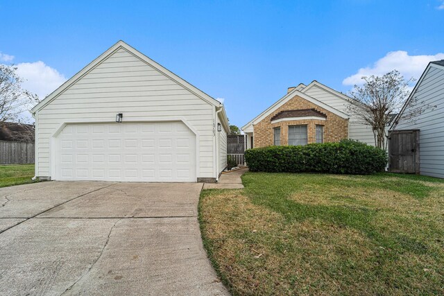 view of front of property featuring a front lawn and a garage