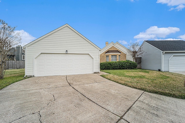 view of front of house featuring a garage and a front lawn