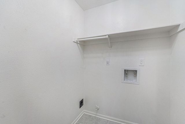 clothes washing area with tile patterned flooring, hookup for an electric dryer, and hookup for a washing machine