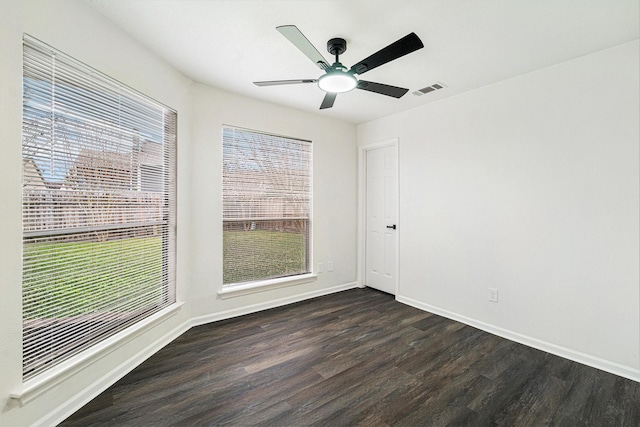 spare room featuring ceiling fan and dark hardwood / wood-style floors