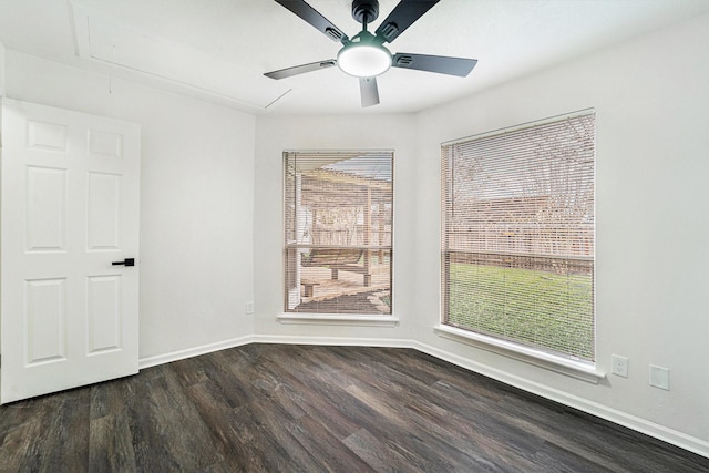 spare room featuring dark wood-type flooring and ceiling fan