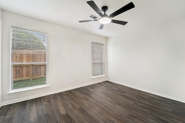 empty room featuring ceiling fan and dark hardwood / wood-style floors