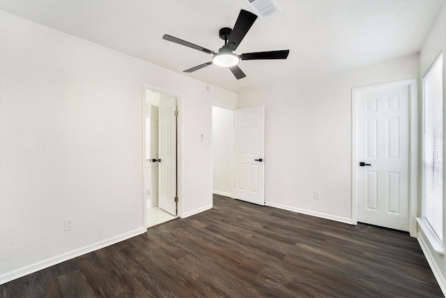 unfurnished bedroom featuring ceiling fan and dark wood-type flooring