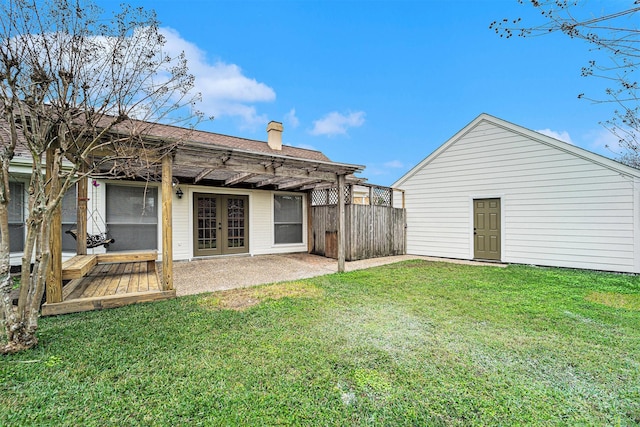 rear view of house featuring a patio area, french doors, a lawn, and a pergola