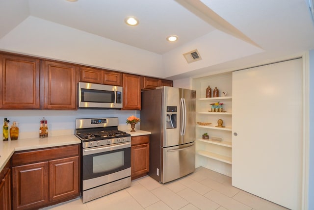 kitchen featuring stainless steel appliances and a raised ceiling