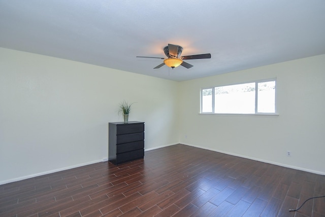 empty room featuring ceiling fan and dark hardwood / wood-style floors