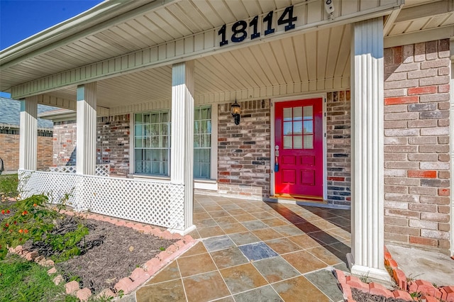 entrance to property featuring a porch