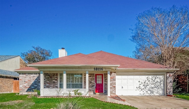 view of front of home with a front lawn and a garage