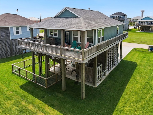 rear view of house with a deck, a yard, and a patio