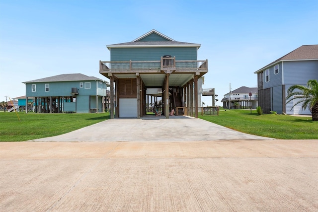 coastal inspired home with a front yard, a garage, a balcony, and a carport