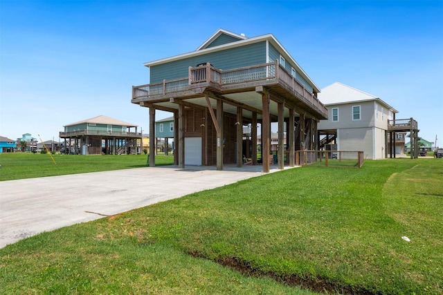 view of front of house featuring a carport, a balcony, a front lawn, and a garage