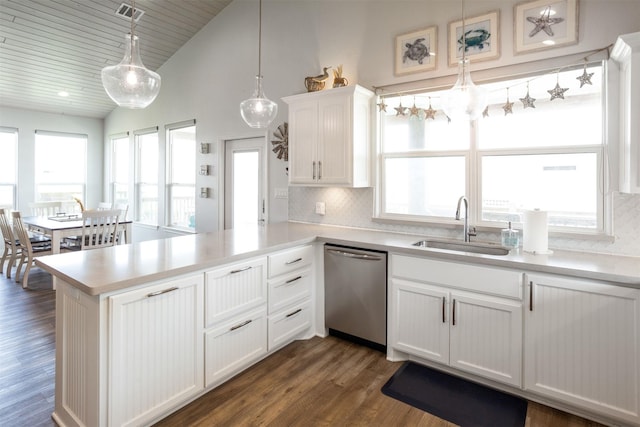 kitchen featuring stainless steel dishwasher, decorative light fixtures, tasteful backsplash, white cabinetry, and sink