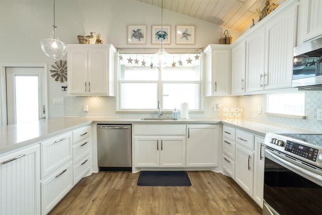 kitchen with decorative light fixtures, stainless steel appliances, sink, and white cabinetry