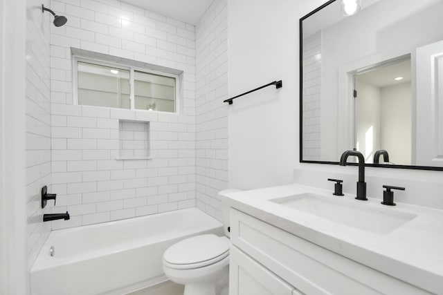 full bathroom with toilet, vanity, and tiled shower / bath