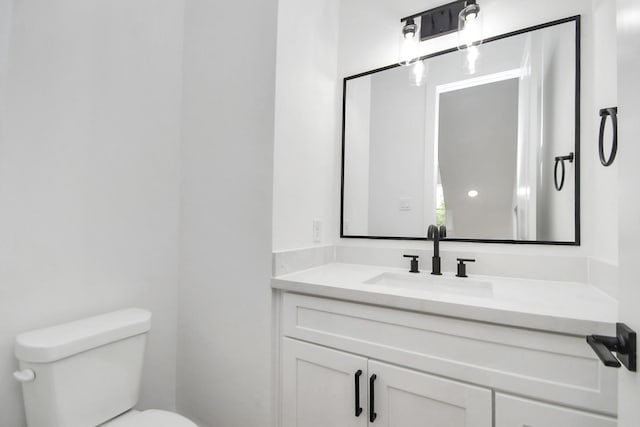 bathroom with toilet and vanity