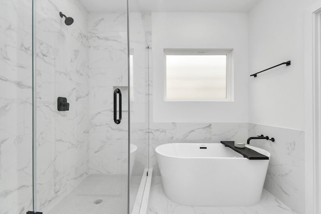 bathroom featuring tile walls and shower with separate bathtub