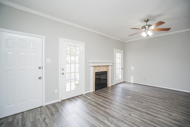 unfurnished living room featuring a fireplace, hardwood / wood-style floors, ceiling fan, and crown molding