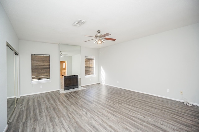 unfurnished living room with ceiling fan and hardwood / wood-style flooring