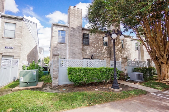 back of house featuring central AC unit