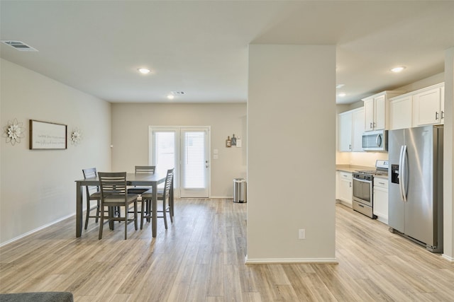 dining area with light hardwood / wood-style flooring