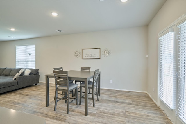 dining space with light wood-type flooring and a wealth of natural light