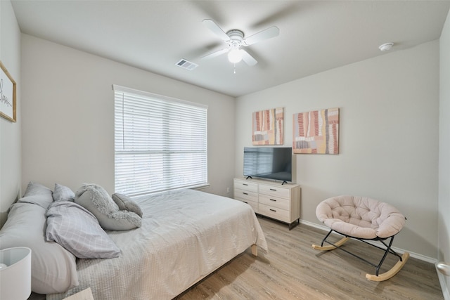 bedroom with ceiling fan and light hardwood / wood-style floors