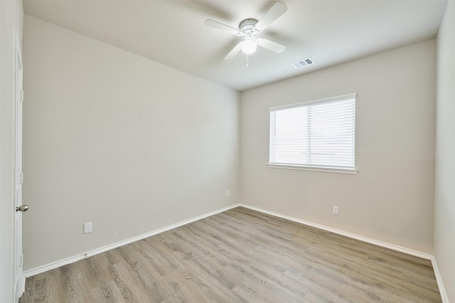 spare room featuring ceiling fan and light hardwood / wood-style flooring