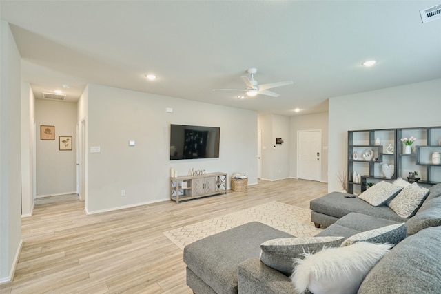 living room with ceiling fan and light hardwood / wood-style floors