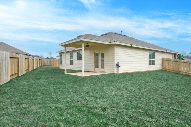 rear view of house with a patio area, ceiling fan, and a lawn