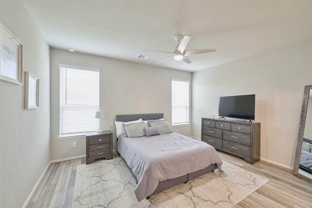 bedroom with ceiling fan and light hardwood / wood-style floors