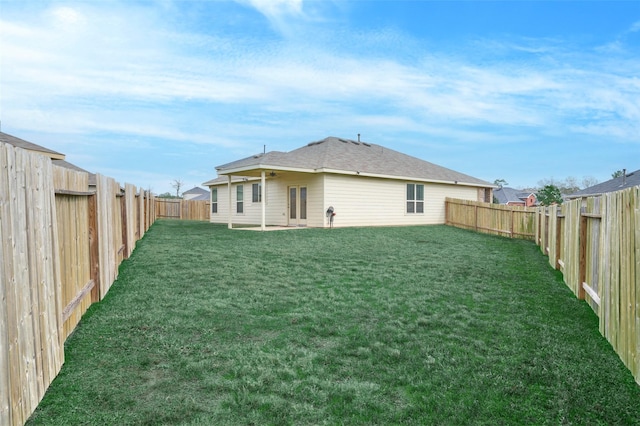 back of house featuring a yard