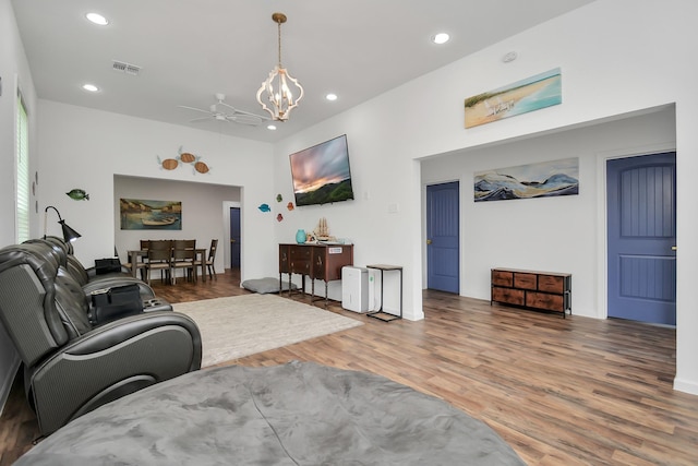 living room featuring wood-type flooring and ceiling fan