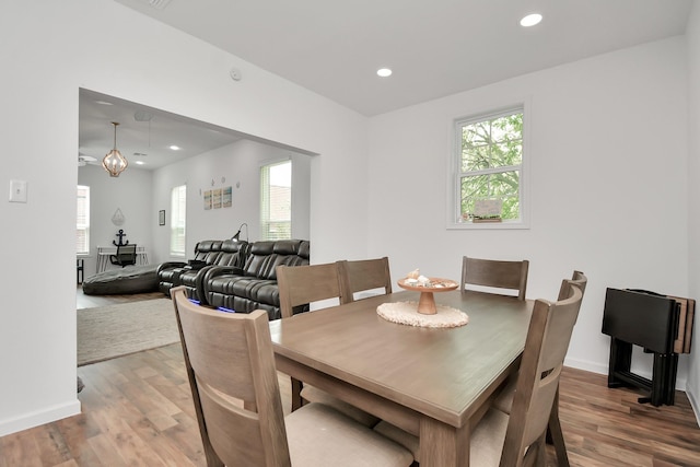 dining room featuring wood-type flooring and a notable chandelier