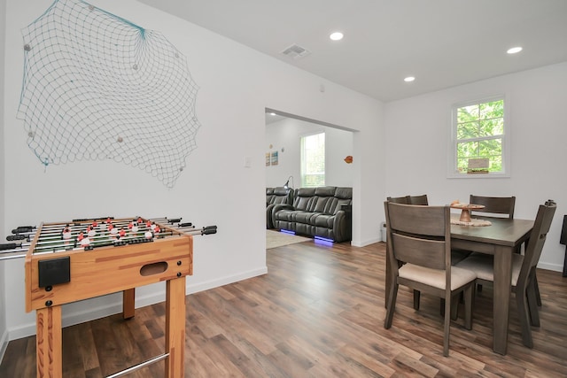 dining room featuring dark wood-type flooring and a wealth of natural light