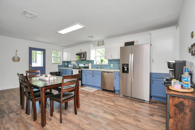 dining space with hardwood / wood-style floors