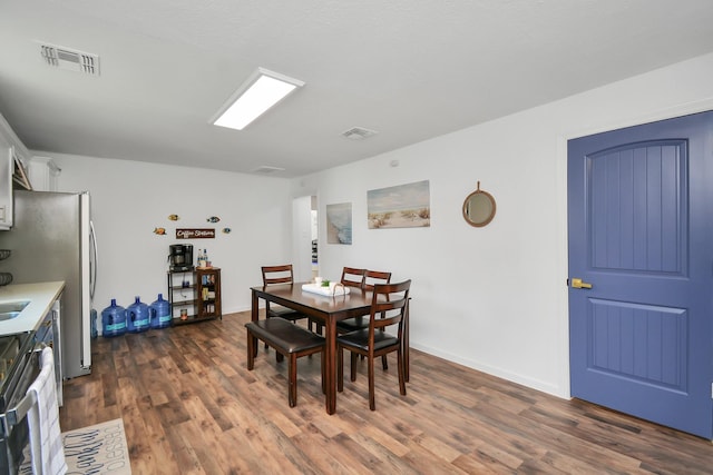 dining space featuring dark wood-type flooring