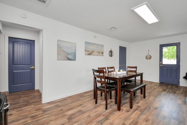 dining area with dark hardwood / wood-style flooring