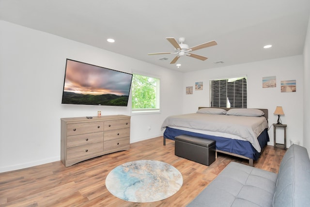 bedroom with ceiling fan and light hardwood / wood-style flooring