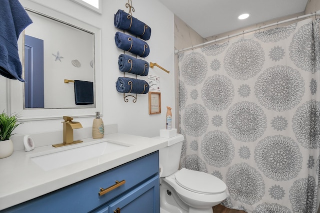 bathroom with toilet and vanity