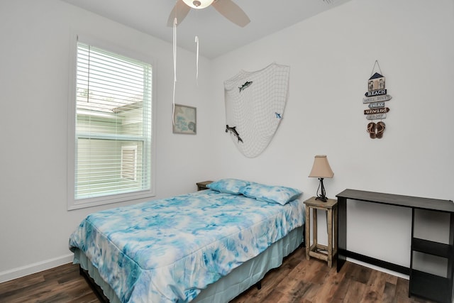 bedroom with ceiling fan and dark hardwood / wood-style floors