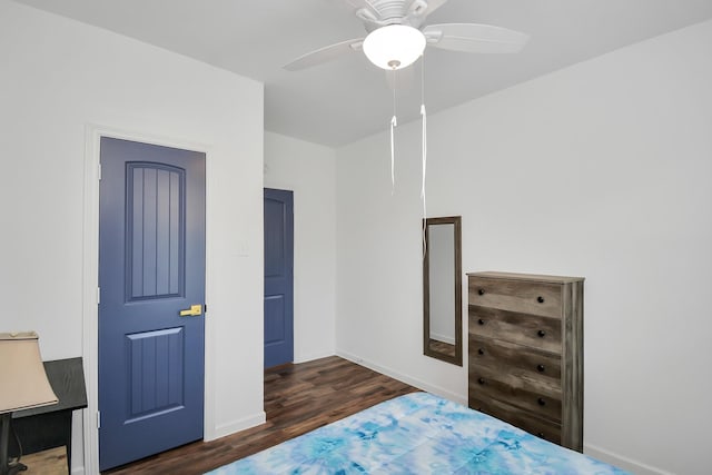 bedroom with ceiling fan and dark hardwood / wood-style flooring