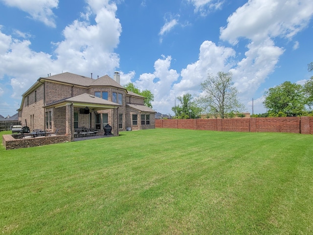 view of yard featuring fence and a patio