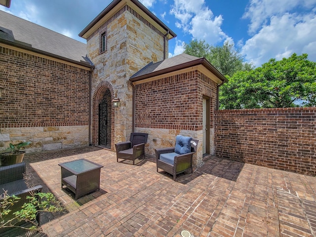 view of patio with an outdoor living space and a garage