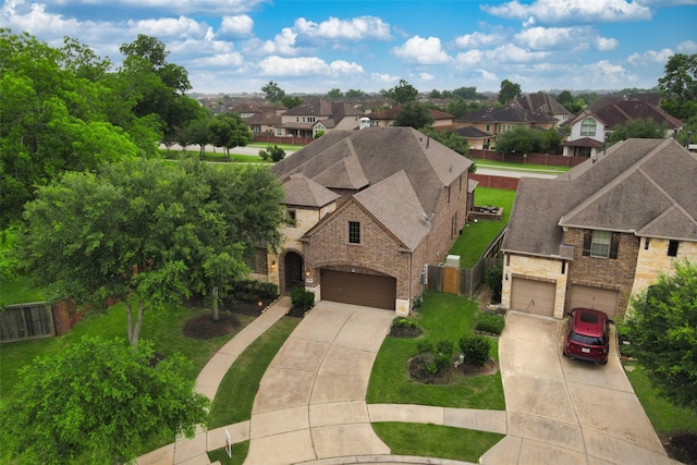 5003 Lockridge Sky Ln, Sugar Land, TX 77479 - view of front of property with concrete driveway, a residential view, stone siding, and a garage